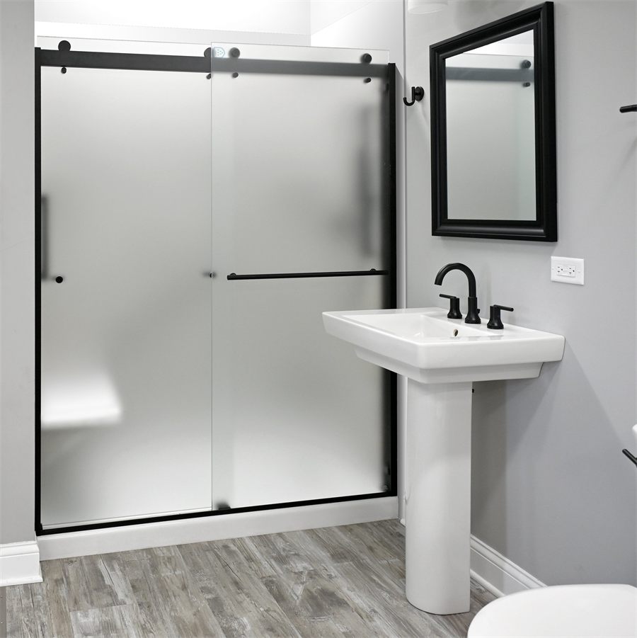 Guest bathroom with a frosted sliding shower door, pedestal basin and black fittings