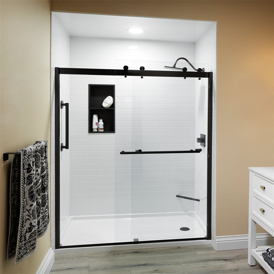Tub-to-shower conversion in white subway tile with a black sliding door and a recessed niche