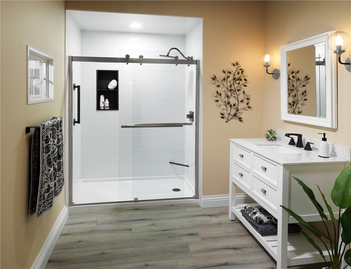 Finished bathroom with a white subway-tiled shower and a white vanity